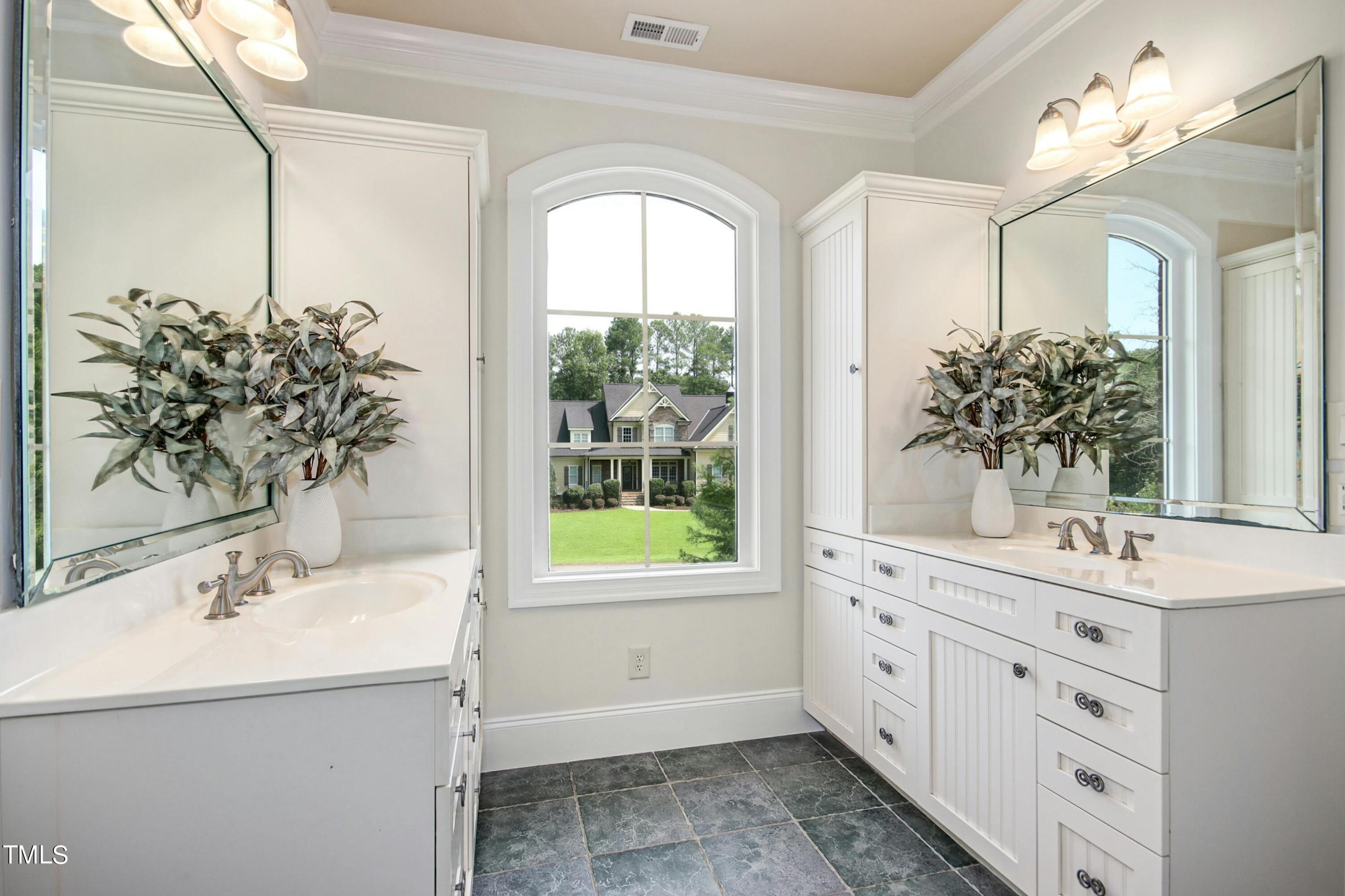 5513 Hickory Leaf Drive Raleigh, NC 27606 - Photo 25 of 41 a bathroom with a sink mirror and a bathtub
