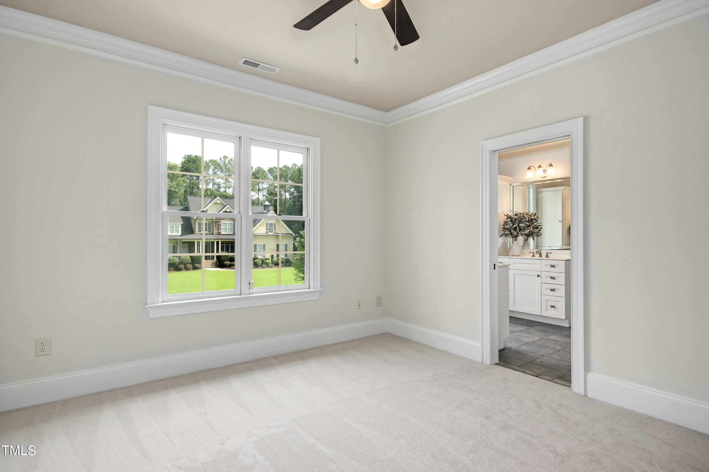 5513 Hickory Leaf Drive Raleigh, NC 27606 - Photo 26 of 41 an empty room with a window and a ceiling fan