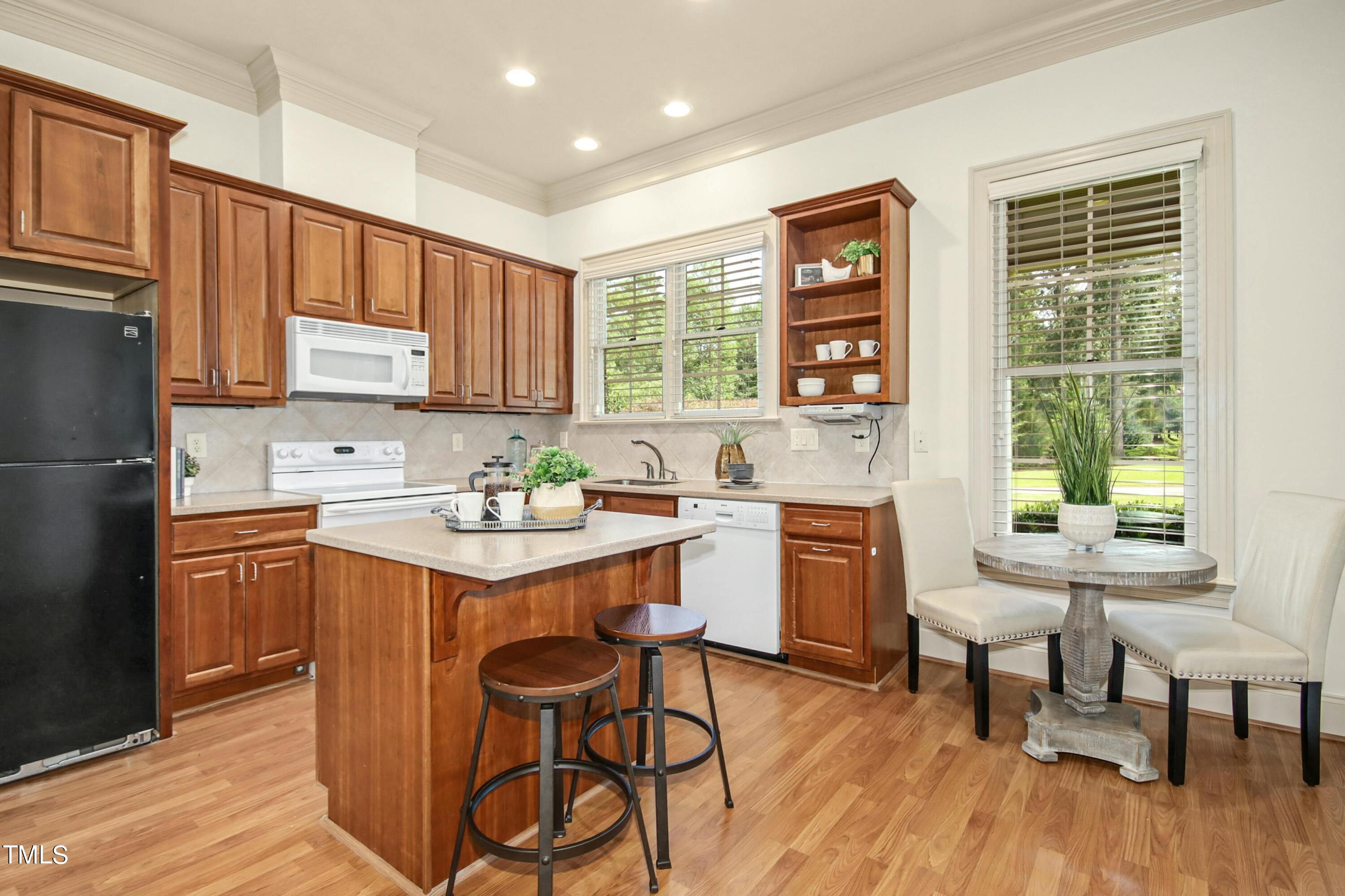 5513 Hickory Leaf Drive Raleigh, NC 27606 - Photo 34 of 41 a kitchen with a sink stove a table and chairs