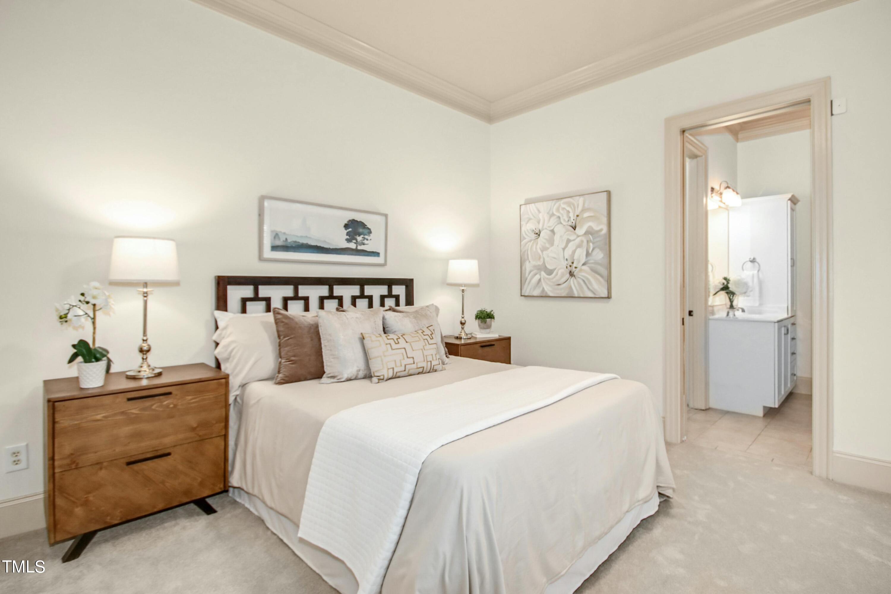 5513 Hickory Leaf Drive Raleigh, NC 27606 - Photo 36 of 41 a bedroom with a bed and a lamp on a dresser