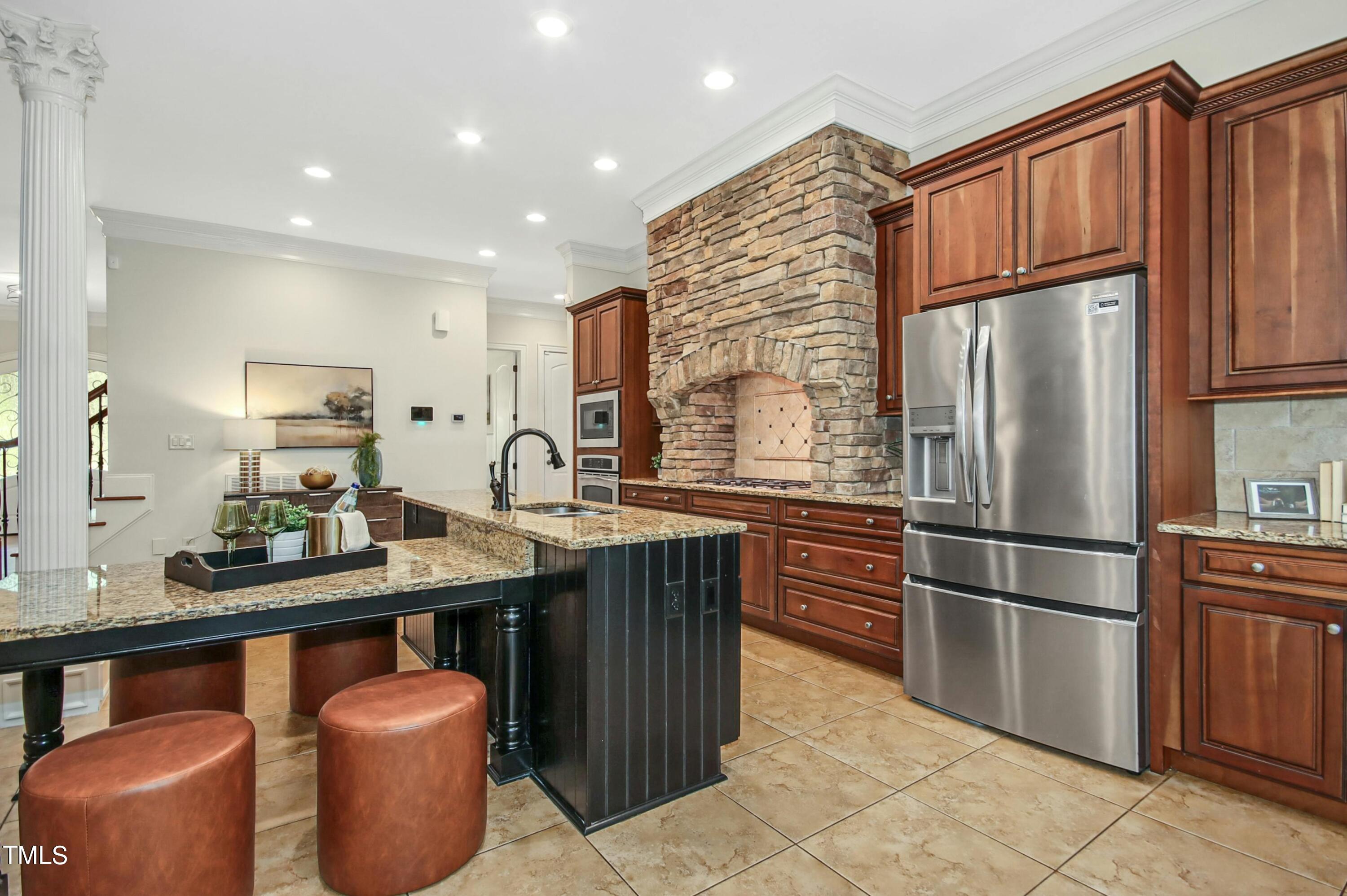 5513 Hickory Leaf Drive Raleigh, NC 27606 - Photo 9 of 41 a kitchen with stainless steel appliances granite countertop a refrigerator sink and cabinets