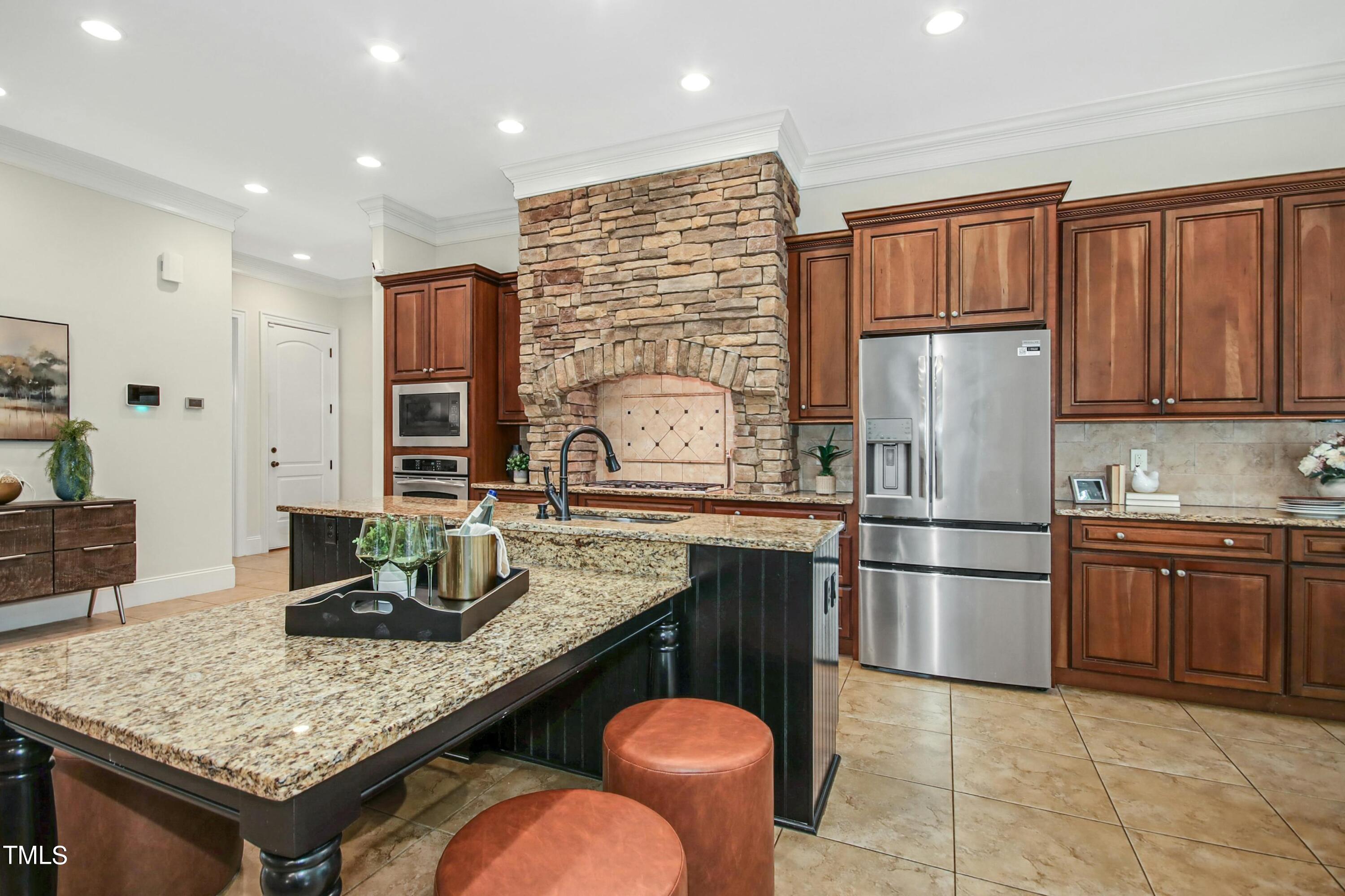 5513 Hickory Leaf Drive Raleigh, NC 27606 - Photo 10 of 41 a kitchen with stainless steel appliances granite countertop a sink refrigerator and cabinets