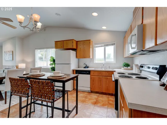 a kitchen with a table chairs stove and cabinets