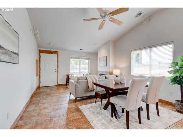 a dining room with furniture and window