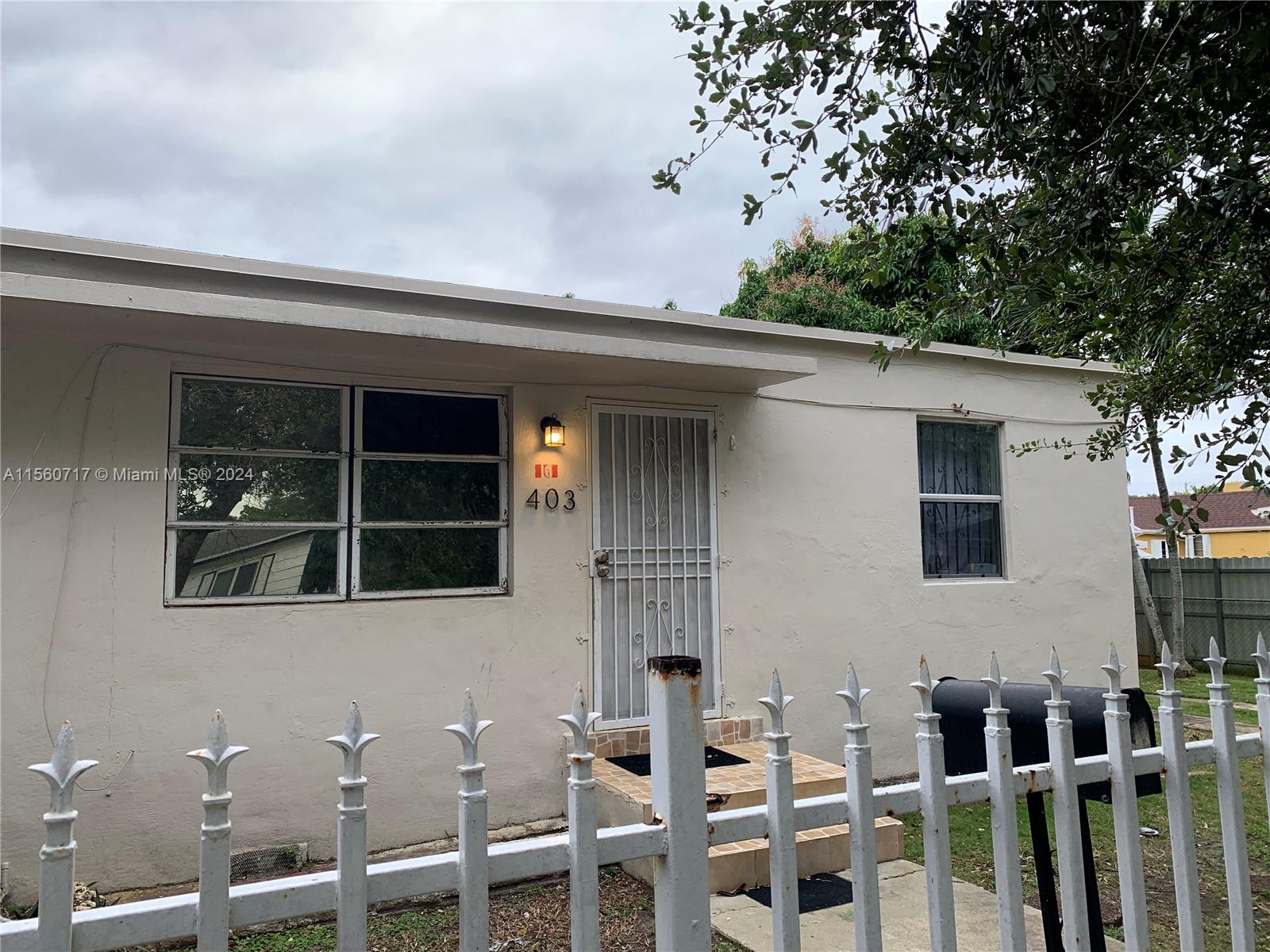 401 Northwest 81st Street Miami, FL 33150 - Photo 2 of 11 a front view of a house with a porch