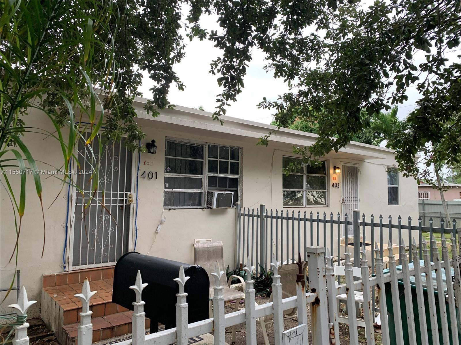 401 Northwest 81st Street Miami, FL 33150 - Photo 3 of 11 a front view of a house with a porch