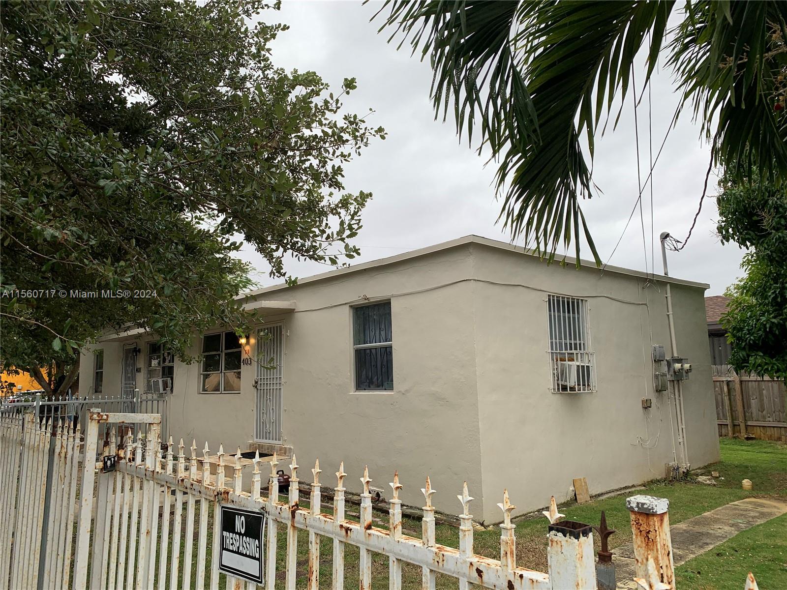 401 Northwest 81st Street Miami, FL 33150 - Photo 5 of 11 a front view of a house with a tree
