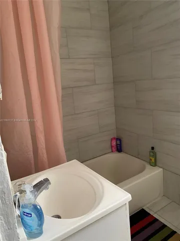 a bathroom with a bathtub and sink