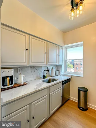 a kitchen with a sink and cabinets