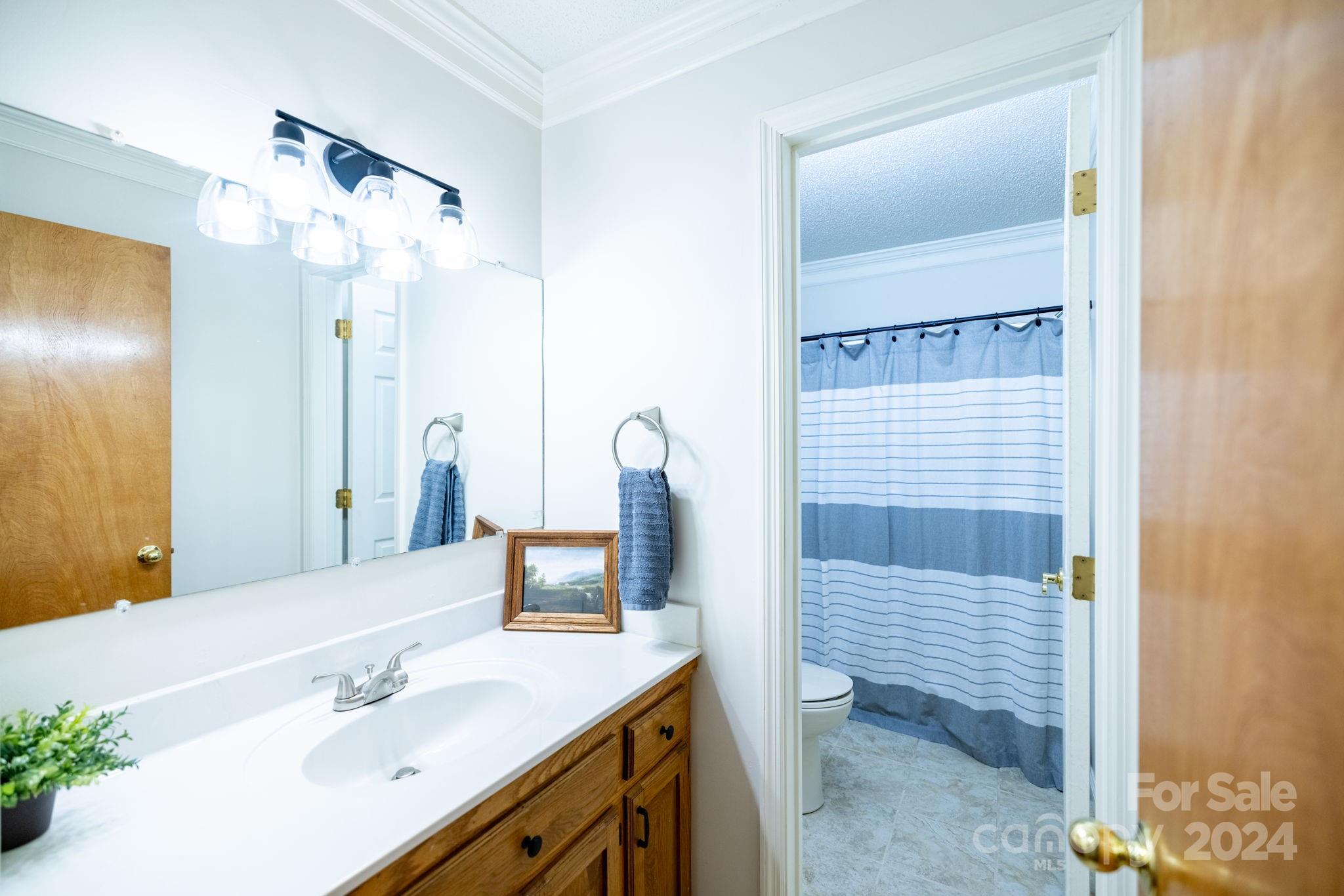 779 Silas Creek Road, Unit 17 & 18 Lansing, NC 28643 - Photo 11 of 35 a bathroom with a sink vanity and mirror