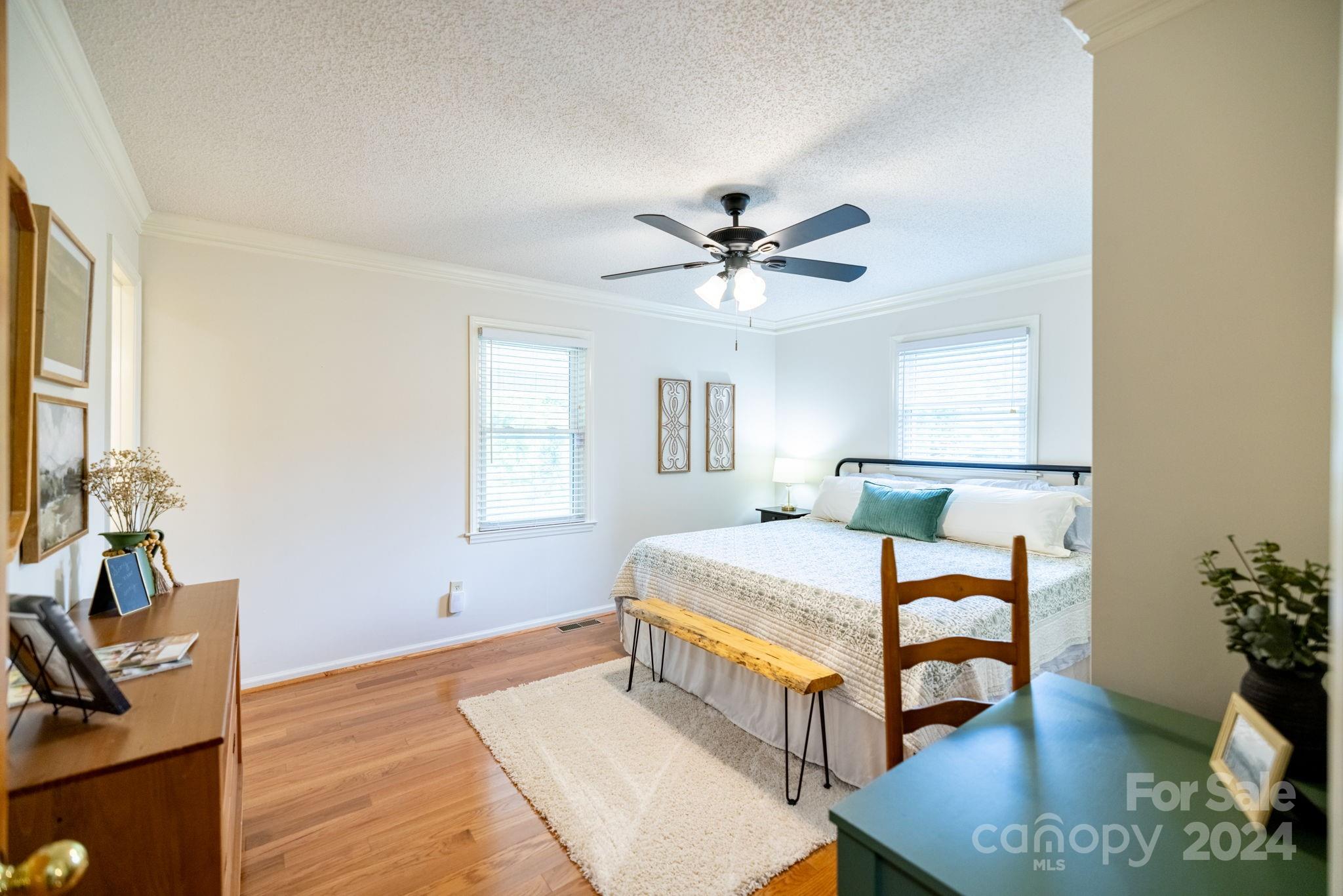 779 Silas Creek Road, Unit 17 & 18 Lansing, NC 28643 - Photo 12 of 35 a bedroom with a bed and a chandelier