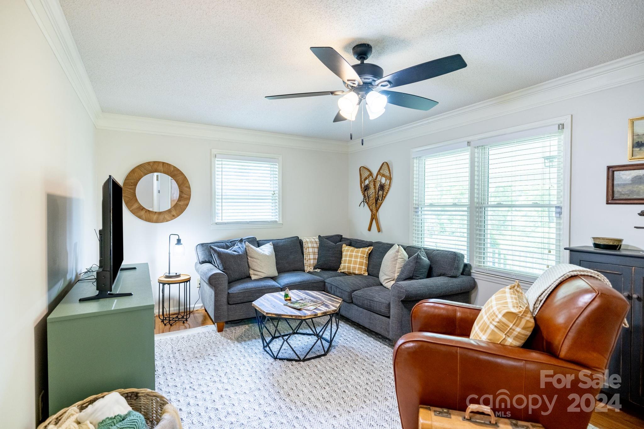 779 Silas Creek Road, Unit 17 & 18 Lansing, NC 28643 - Photo 5 of 35 a living room with furniture a window and a chandelier