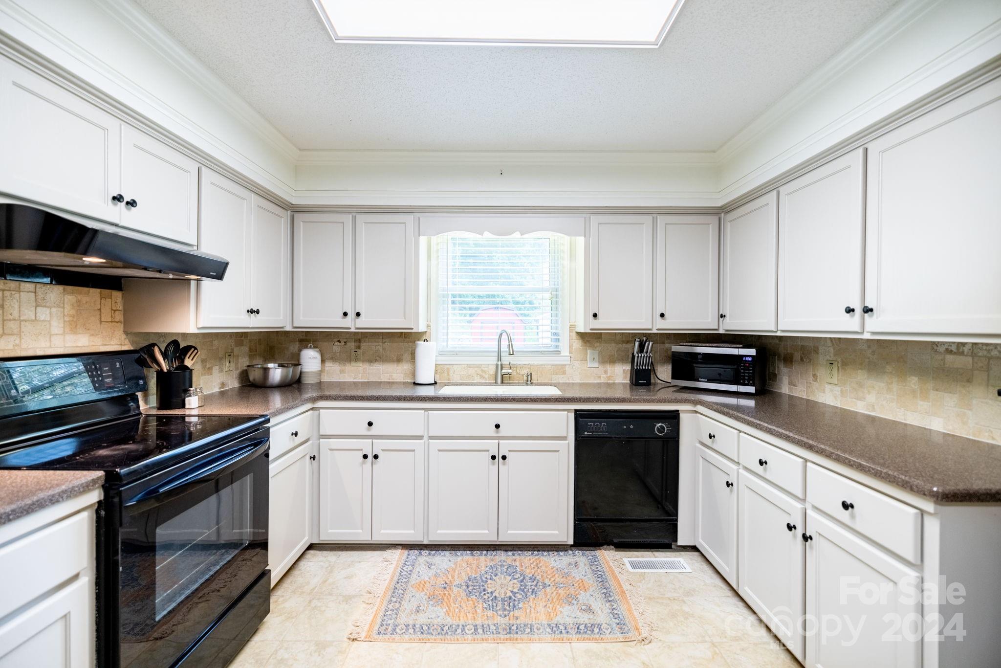 779 Silas Creek Road, Unit 17 & 18 Lansing, NC 28643 - Photo 8 of 35 a kitchen with cabinets appliances and a sink