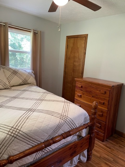 2050 Limekiln Road Tennessee Ridge, TN 37178 - Photo 16 of 37 a bedroom with a bed and wooden floor