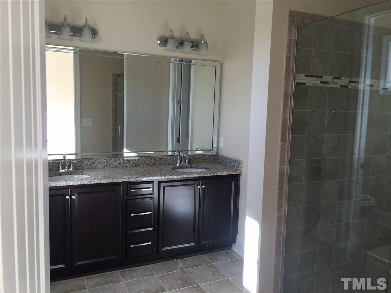 704 Fallon Grove Way Raleigh, NC 27608 - Photo 9 of 15 a bathroom with a granite countertop sink and a mirror