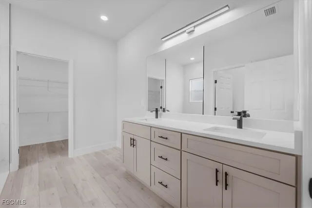 a bathroom with a double vanity sink and mirror
