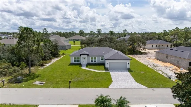 an aerial view of multiple houses with a swimming pool