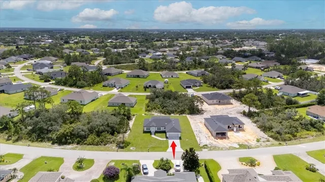 an aerial view of residential houses with outdoor space and swimming pool