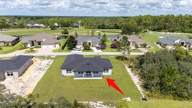 an aerial view of residential houses with outdoor space