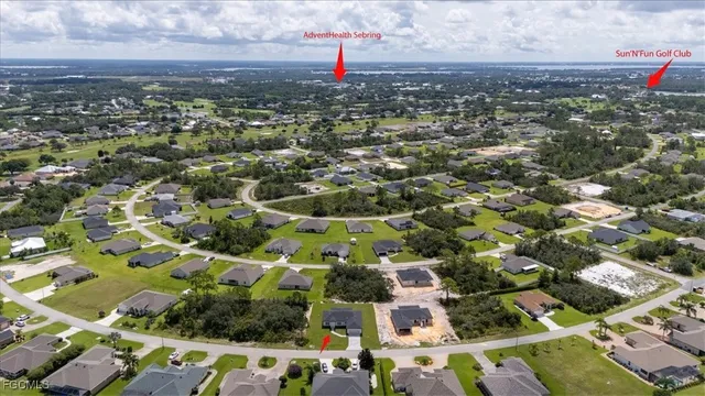 an aerial view of a house with outdoor space and a lake view