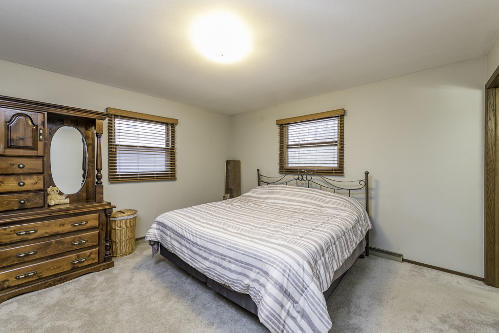 2009 Kedron Boulevard Zion, IL 60099 - Photo 15 of 30 a bedroom with a bed a dresser and a window