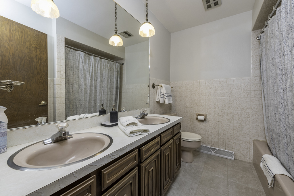 2009 Kedron Boulevard Zion, IL 60099 - Photo 16 of 30 a bathroom with a double vanity sink toilet and a mirror