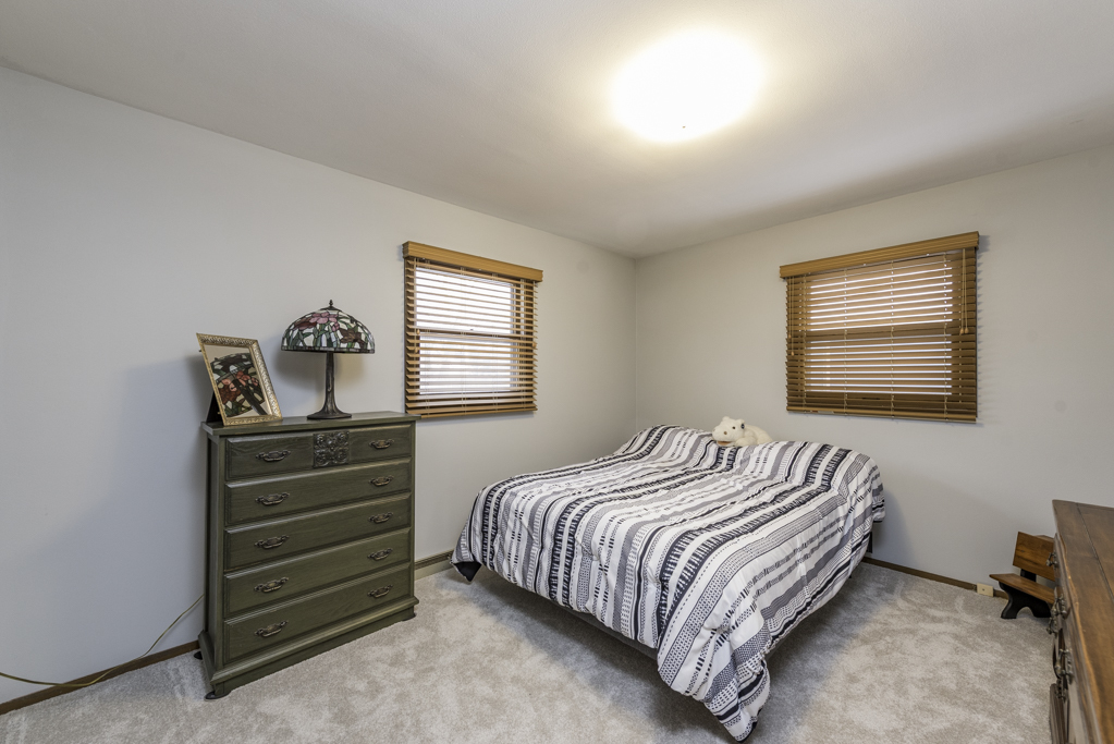 2009 Kedron Boulevard Zion, IL 60099 - Photo 18 of 30 a bedroom with a bed and a dresser next to a window