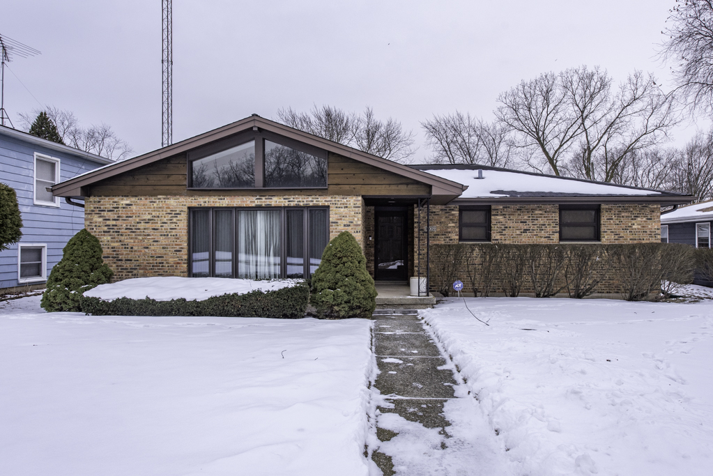 2009 Kedron Boulevard Zion, IL 60099 - Photo 2 of 30 a front view of a house with a yard and potted plants
