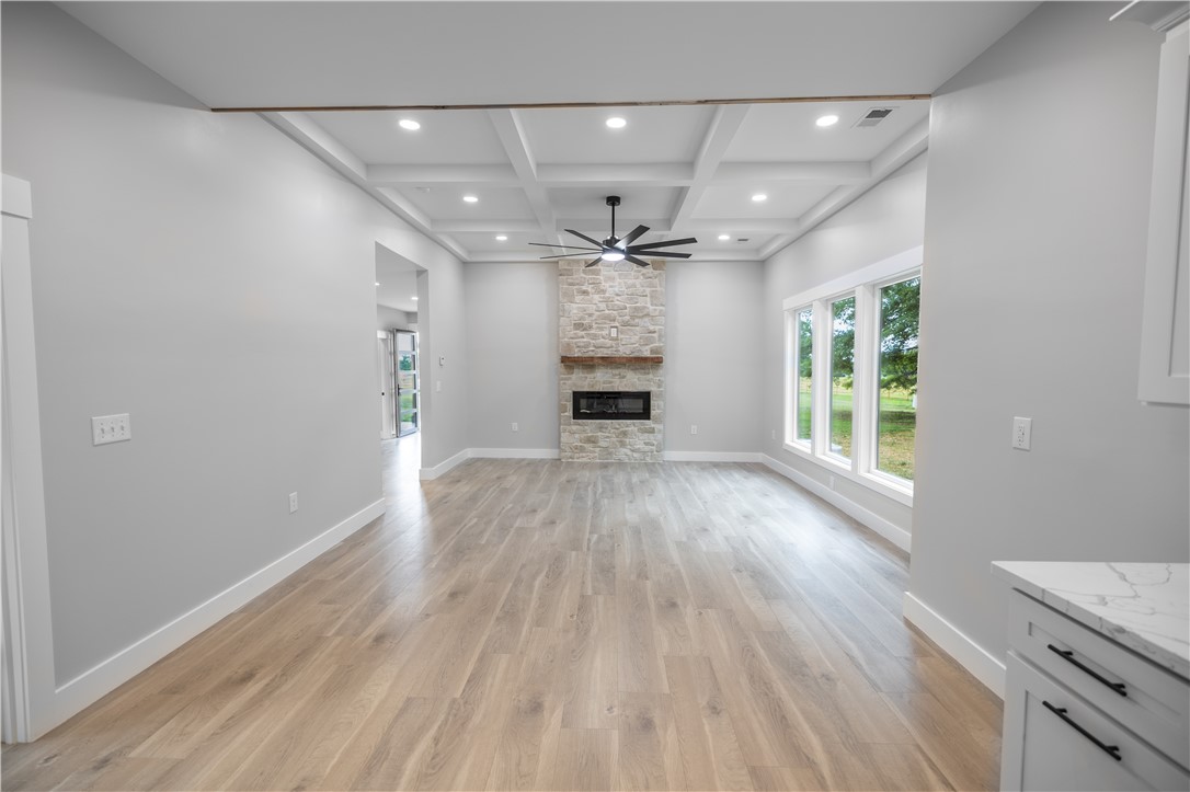 2817 Broadway Lake Road Anderson, SC 29621 - Photo 28 of 41 A spacious living area with hardwood floors, a stone fireplace, and abundant natural light from generous windows.