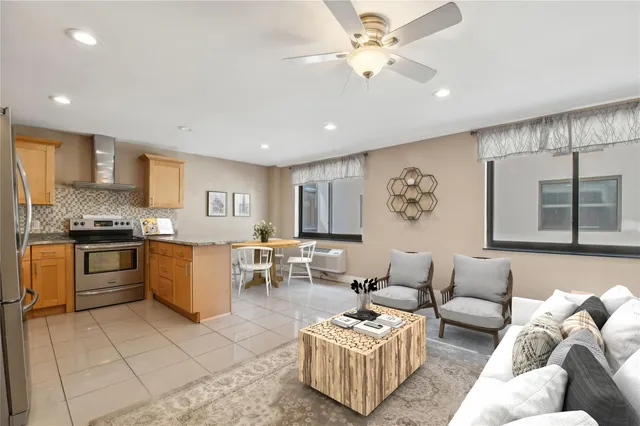 a living room with furniture and kitchen view