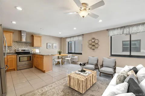 a living room with furniture and kitchen view