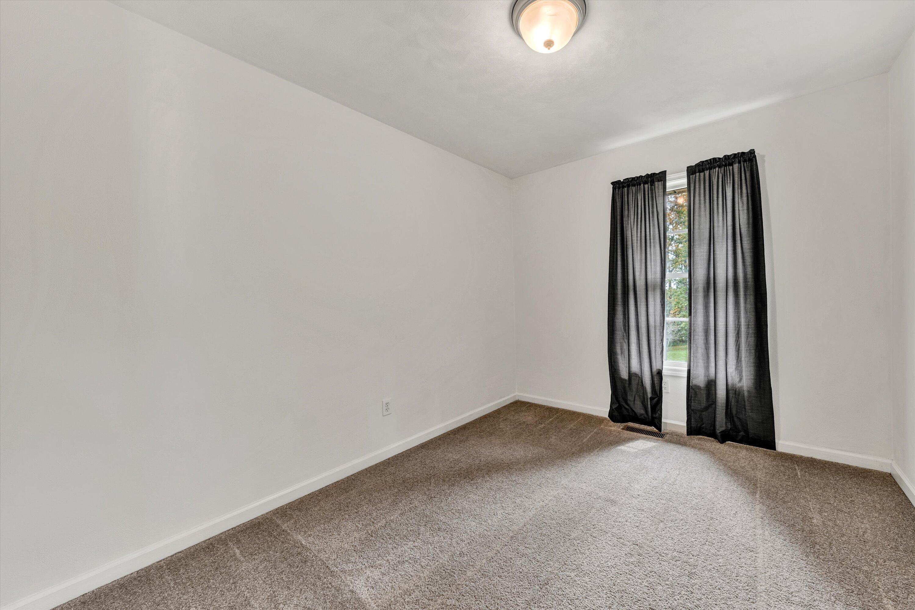 4291 Mill Iron Road Goodview, VA 24095 - Photo 13 of 33 a view of an empty room with a window