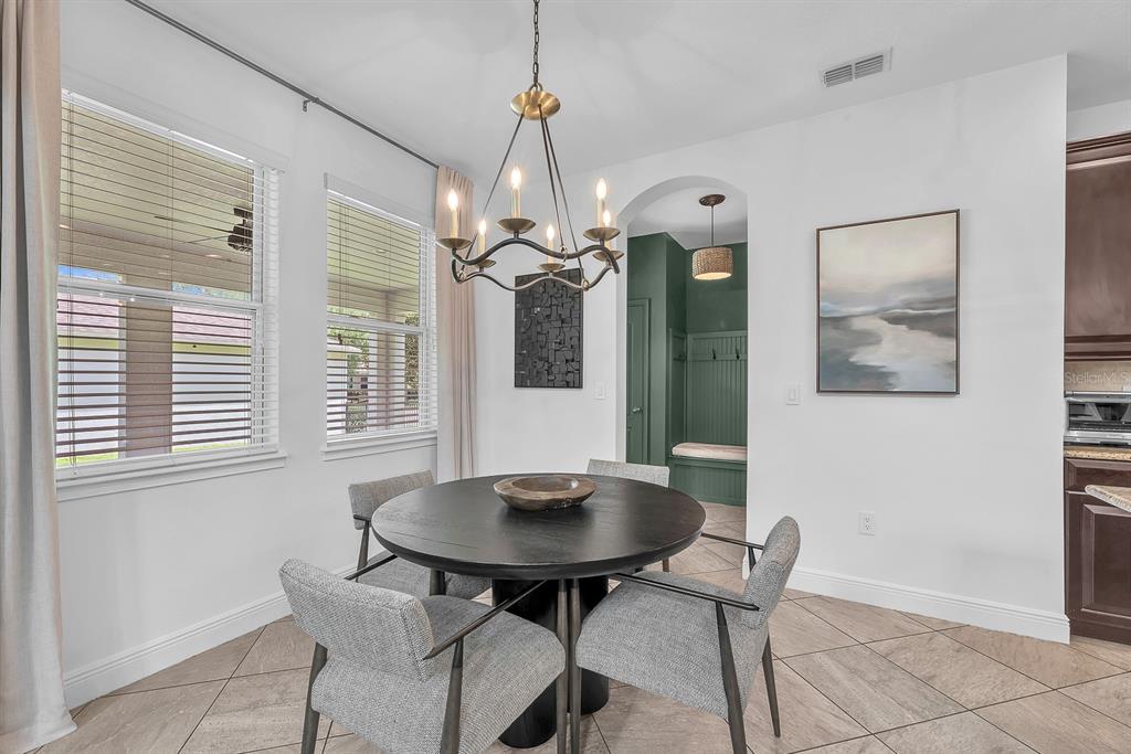 5310 Fishhawk Ridge Drive Lithia, FL 33547 - Photo 17 of 52 a view of a dining room with furniture and chandelier