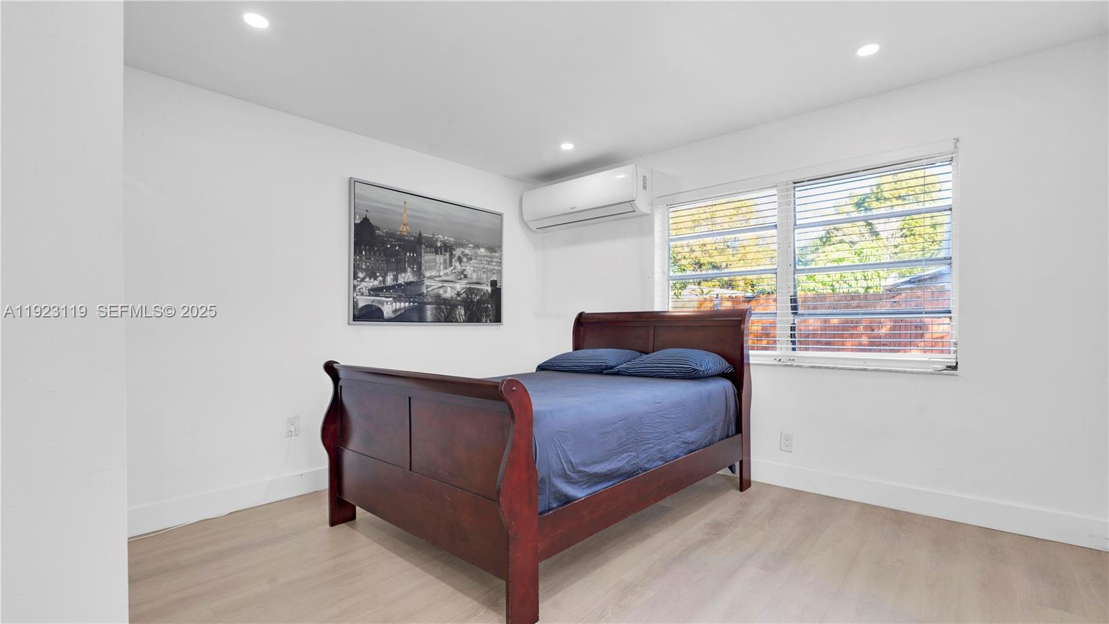 32 Southwest 9th Street, Unit 2 Hallandale Beach, FL 33009 - Photo 12 of 19 a bedroom with a bed and a window