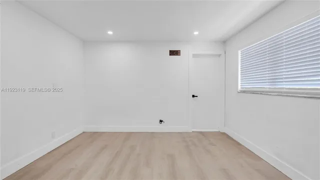 a kitchen with cabinets and window