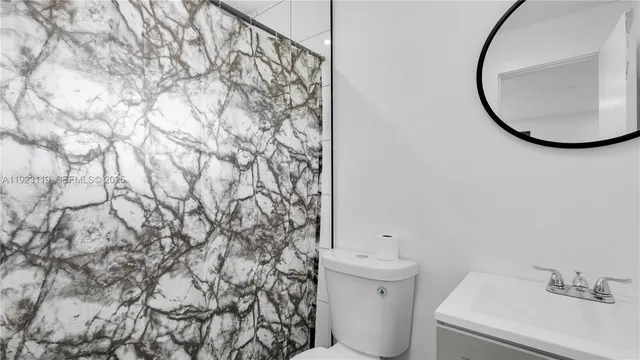 a bathroom with a shower curtain and a sink