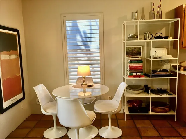 a view of a dining room with furniture and window