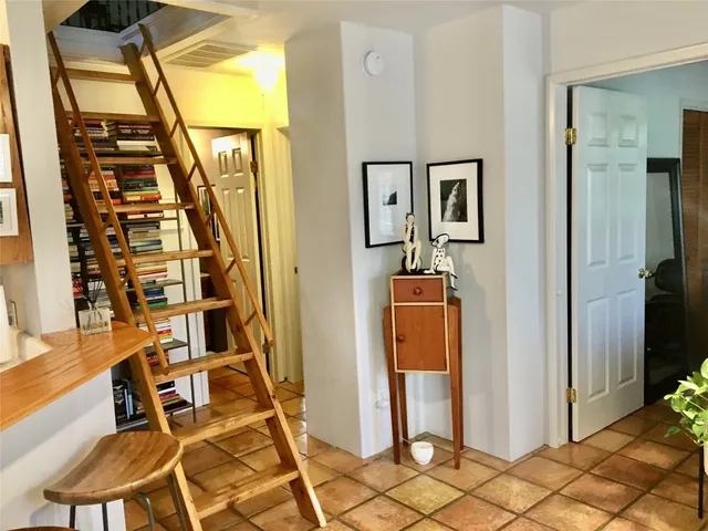 a front view of a house with wooden floor and windows