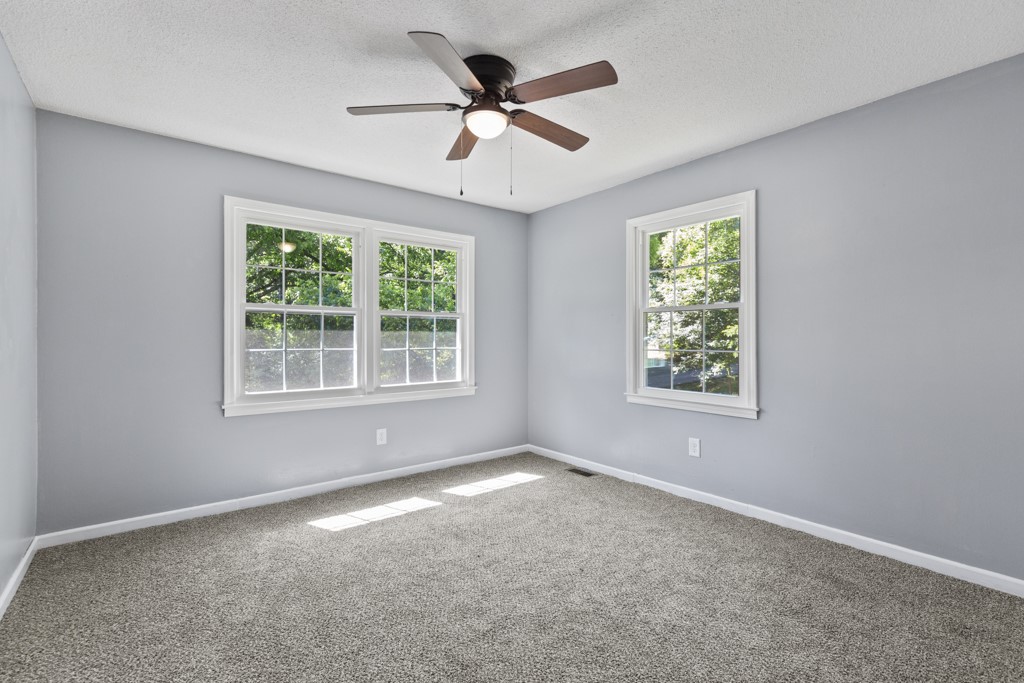 104 Doyle Drive Seneca, SC 29678 - Photo 11 of 19 This airy bedroom offers a tranquil retreat with bright windows and plush carpeting.