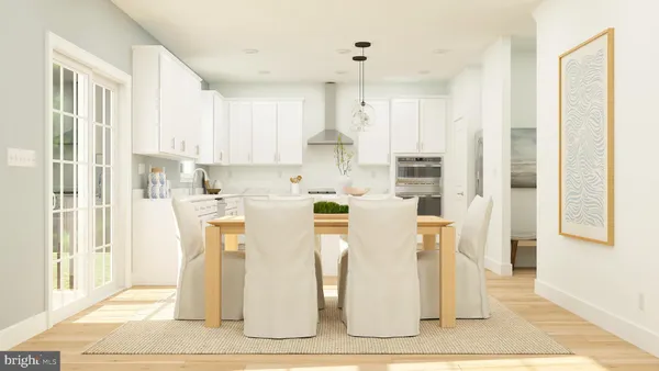 a kitchen with stainless steel appliances kitchen island granite countertop a refrigerator a stove a sink and white cabinets with wooden floor