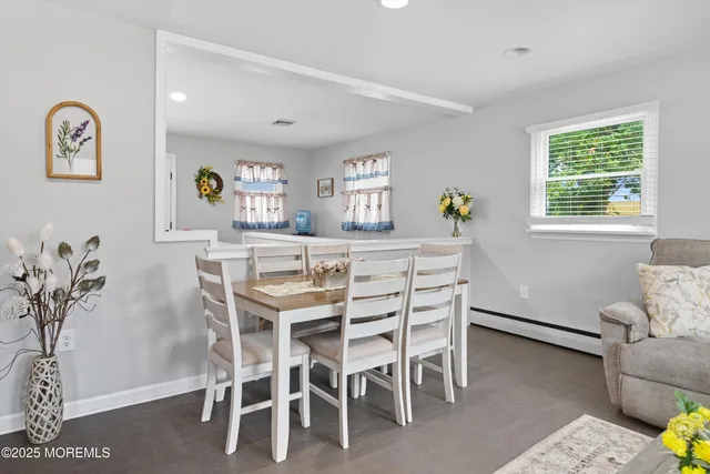 a dining room with furniture and window
