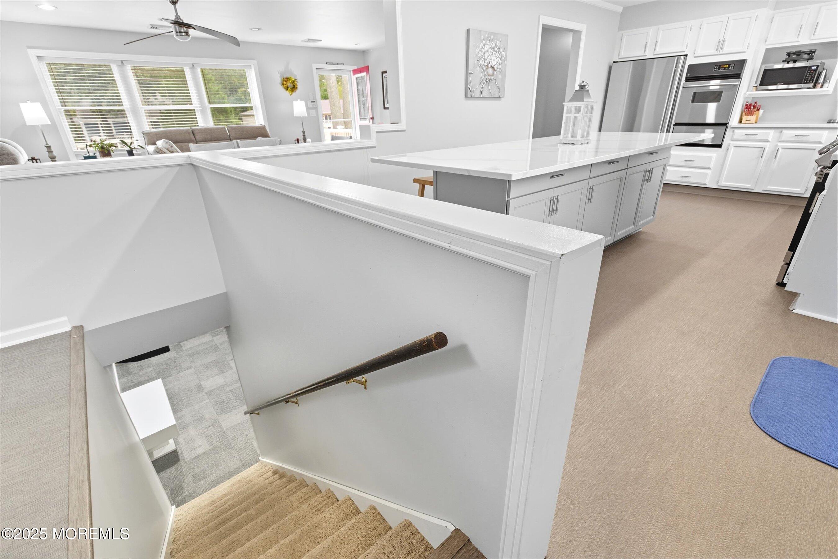 210 Coolidge Avenue Absecon, NJ 08201 - Photo 12 of 28 a living room with couches and kitchen view with wooden floor