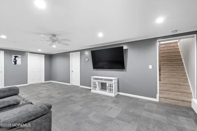 a living room with a flat screen tv and white walls