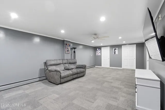 a living room with furniture and a large mirror