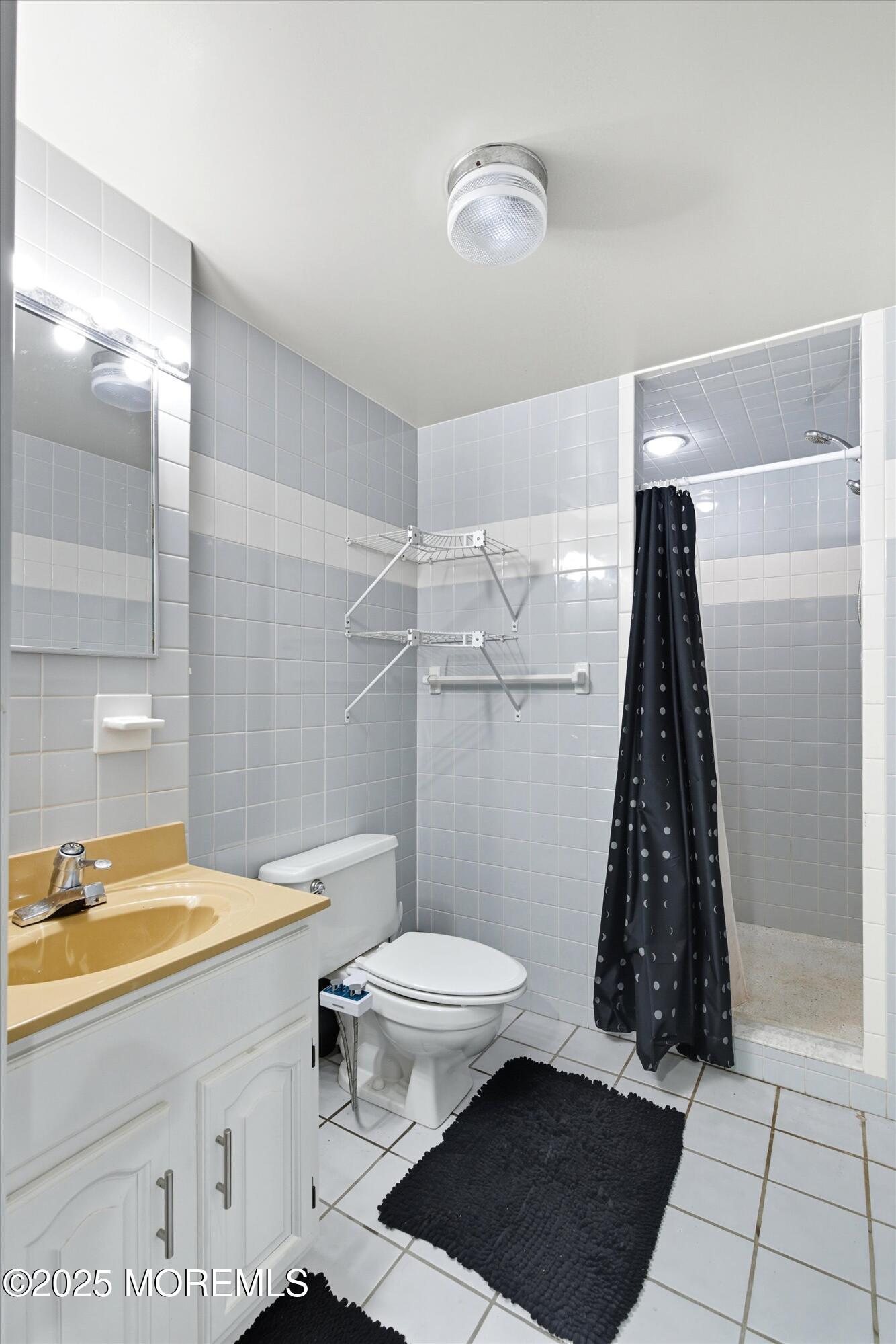 210 Coolidge Avenue Absecon, NJ 08201 - Photo 20 of 28 a bathroom with a sink a toilet a mirror and shower