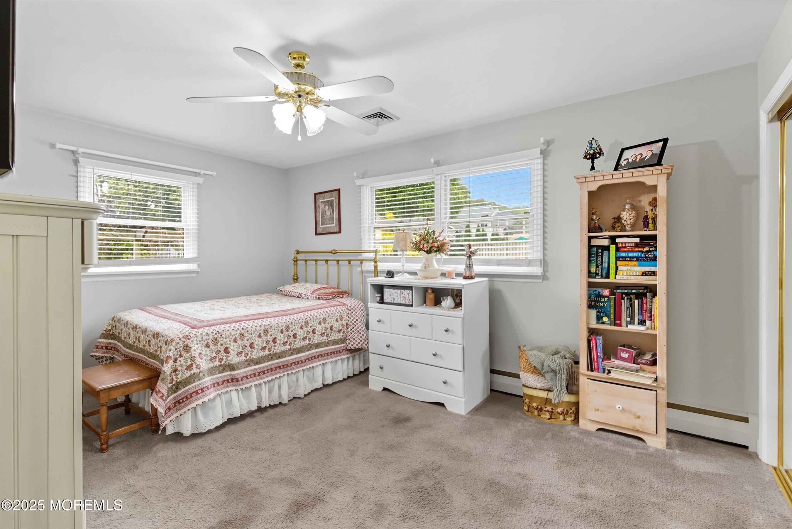 210 Coolidge Avenue Absecon, NJ 08201 - Photo 21 of 28 a spacious bedroom with a bed and a ceiling fan