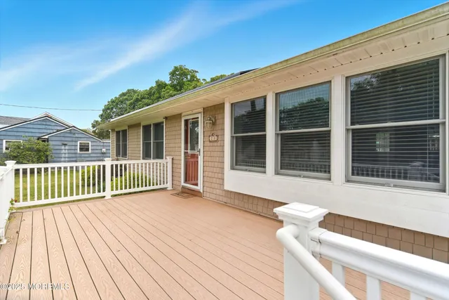 a view of a house with wooden deck