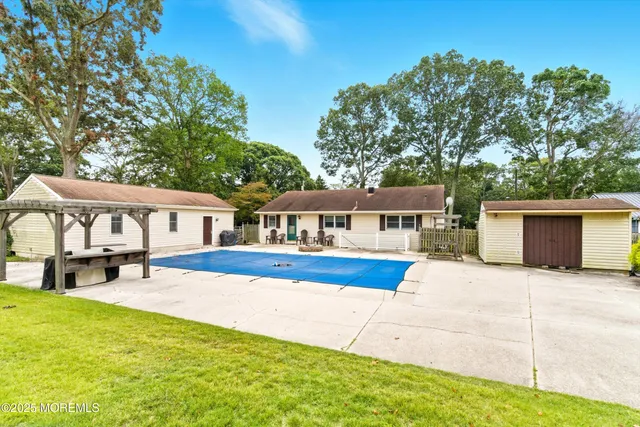 a front view of a house with yard and sitting area