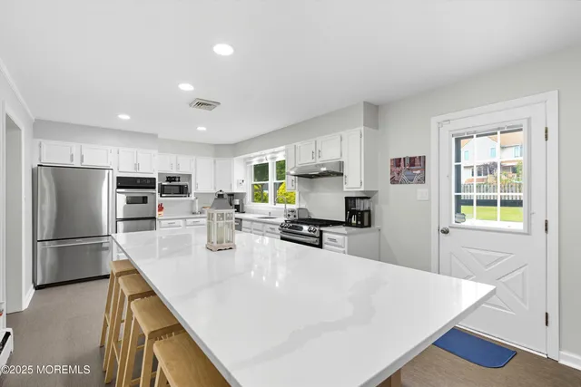 a kitchen with stainless steel appliances a refrigerator and a sink