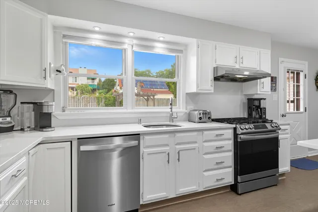 a kitchen with stainless steel appliances granite countertop a stove and a sink